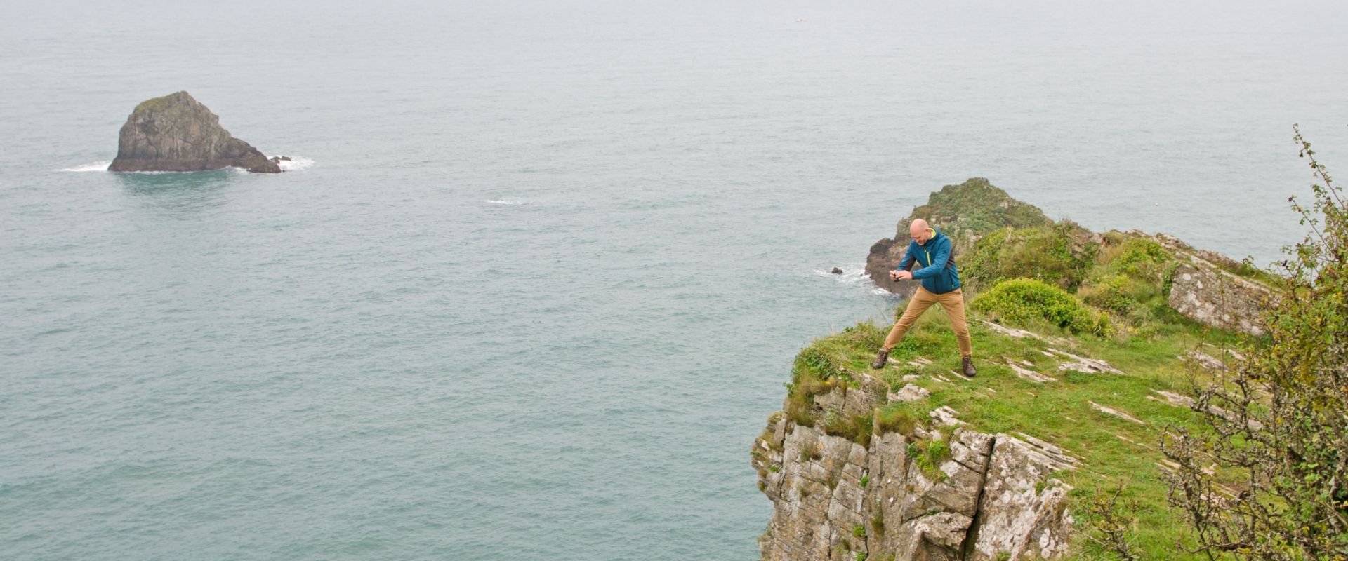 Guest looking over the cliffs into the sea below at Berry Head near Brixham